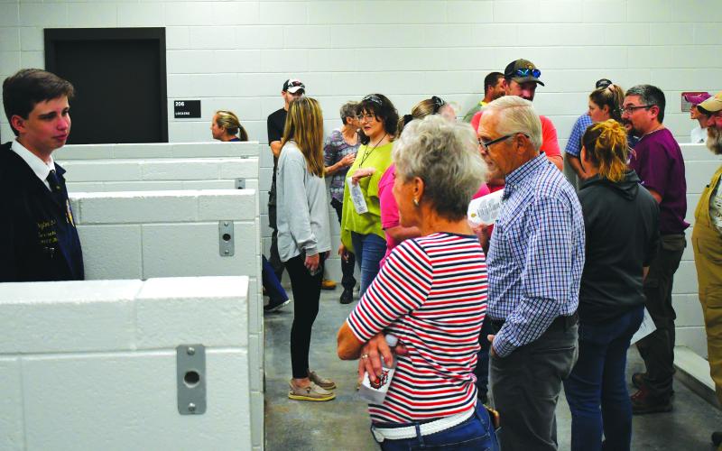 Enoch Autry/The Clayton Tribune.  Peyton Hicks, RCHS FFA secretary, talks to those at the ribbon-cutting Oct. 6 event about the swine barn at the Agri-Science Center.