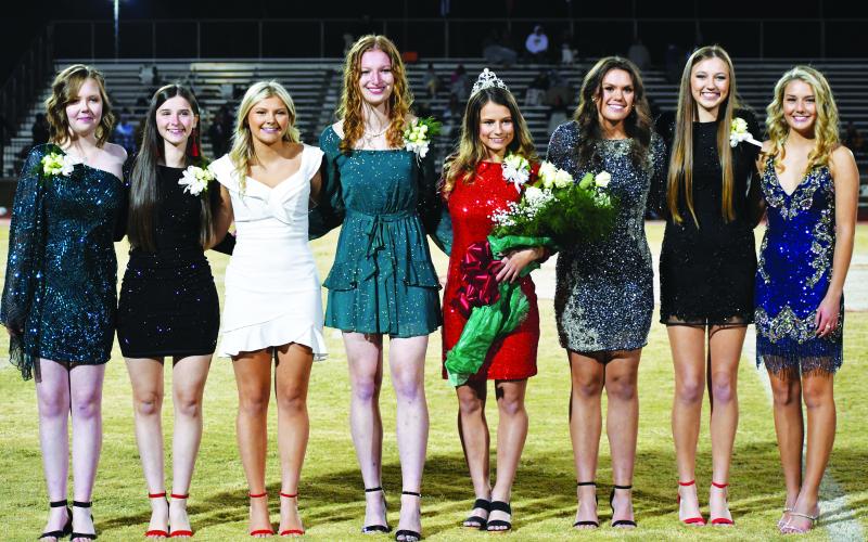 Luke Morey/The Clayton Tribune. During the halftime ceremony of the Rabun County-Athens Christian football game on Oct. 21, the RCHS Homecoming Court poses with this year's Queen Rainny Patterson. From left are Addy Miller (ninth grade); Andrea Green (10th grade); Cadence Dotson (senior); Mira Tinnefeld (11th grade); senior Queen Rainny Patterson; Bailey Maloney (senior); Natalie Watson (senior); and Trea Blalock (senior).