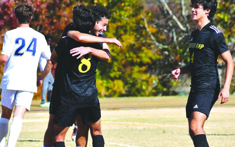 Luke Morey/The Clayton Tribune.  Junior Marcelo Gonzalez celebrates his penalty kick goal with senior Emilio Roman (8) and junior Guillermo Haro on Saturday.