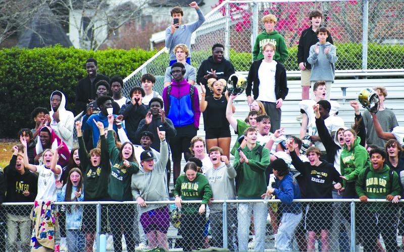 Luke Morey/The Clayton Tribune. Rabun Gap students, including members of the football, golf and volleyball team, celebrate as the buzzer hits zero on Tuesday, sending the Eagles to the State Championship game on Saturday.