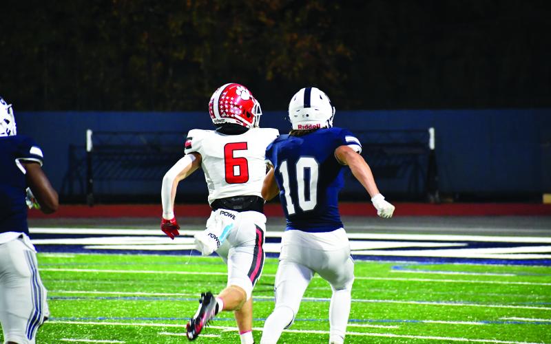 Luke Morey/The Clayton Tribune. RCHS’s Jaden Gibson pulls away from cornerback Sawyer Stock for his first touchdown of the night on a 73-yard pass and run from fellow senior Keegan Stover. Gibson ended with nine catches for 178 yards and two scores.