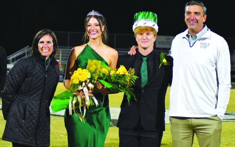 Enoch Autry/The Clayton Tribune. Homecoming Queen Cheney Moriarty and King Zeke Coghill pose with Head of School Jeff Miles and wife Kiana Miles.
