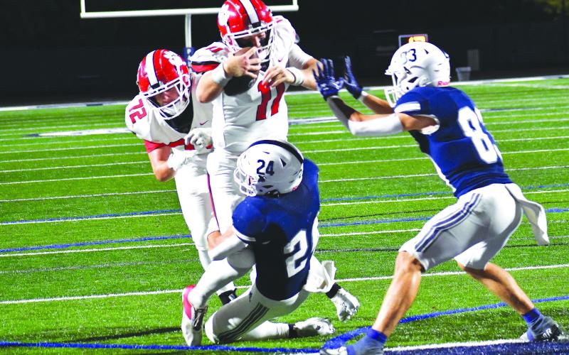 Luke Morey/The Clayton Tribune. RCHS senior quarterback Keegan Stover powers his way into the end zone as he is helped by a push from senior center Skip Speed (72).