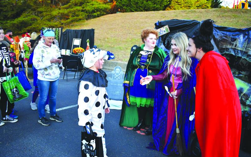 Enoch Autry/The Clayton Tribune. Carlie Pennington (from right), Catie Lovell and Kelcey Reece from Traces of Tiger were among the dozens of groups giving out candy.