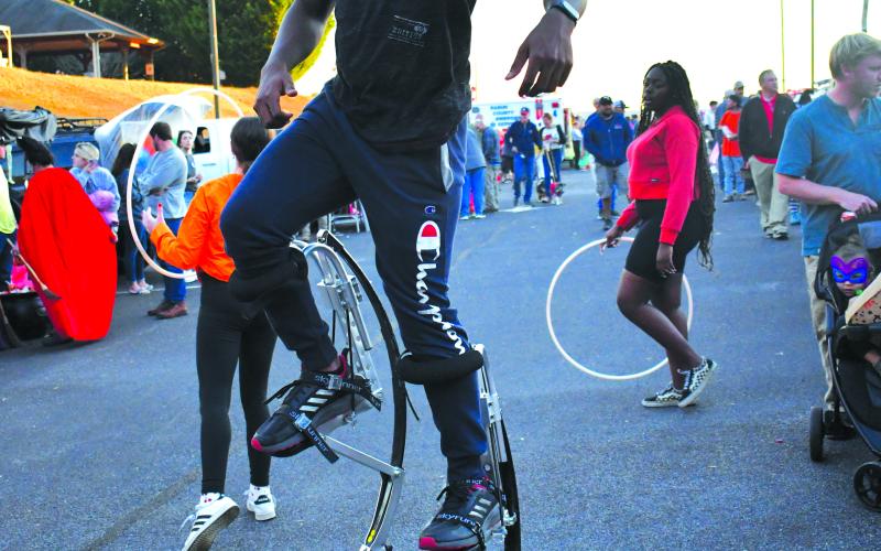 Enoch Autry/The Clayton Tribune. Davien Satterthwaite walks on his Skyrunner Adult Kangaroo Shoes at the event.