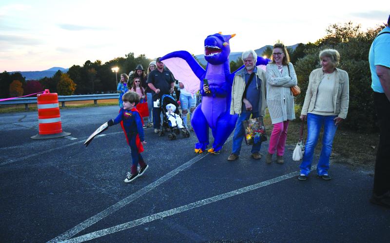 Enoch Autry/The Clayton Tribune. Waiting in line to get to the candy also can be fun when you have a winged dragon, Superman and Pillsbury Dough Boy joining in with the community event.