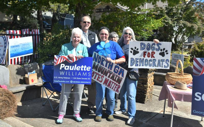 Megan Broome/The Clayton Tribune. The Rabun County Democrats and Georgia State Senate Post 50 Candidate Paulette Williams hold up campaign signs and meet-and-greet community members at the Rock House in Clayton Oct. 14. Pictured with Williams are Susan Brewer, Janice Cochrane; Back row: Bill Stueck, Rabun County Democratic Party vice chair, and Dee Daley.