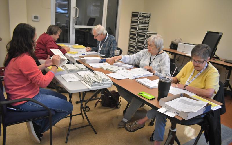 Megan Broome/The Clayton Tribune. Poll workers are gearing up for early voting and the Nov. 8 election. Shay Harbin, office assistant; and absentee poll workers Elaine Lawson; Rick Crouse; Mary Ann Rich; and Virginia Anderson work to mail out absentee ballots to voters on Tuesday.
