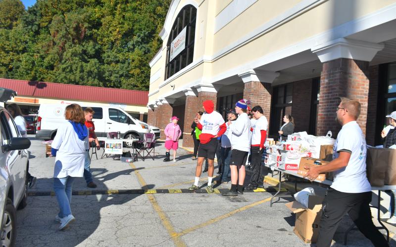 Megan Broome/The Clayton Tribune. The Rabun County Sheriff’s Office, other law enforcement agencies and the faith community came together October 8 at the Food Bank of Northeast Georgia to distribute food, diapers and educational resources to community members during National Faith &amp; Blue Weekend. Law enforcement personnel with Safe Kids Rabun conducted car and booster seat safety checks and car seat technicians were available to check seats for proper fit and installation.