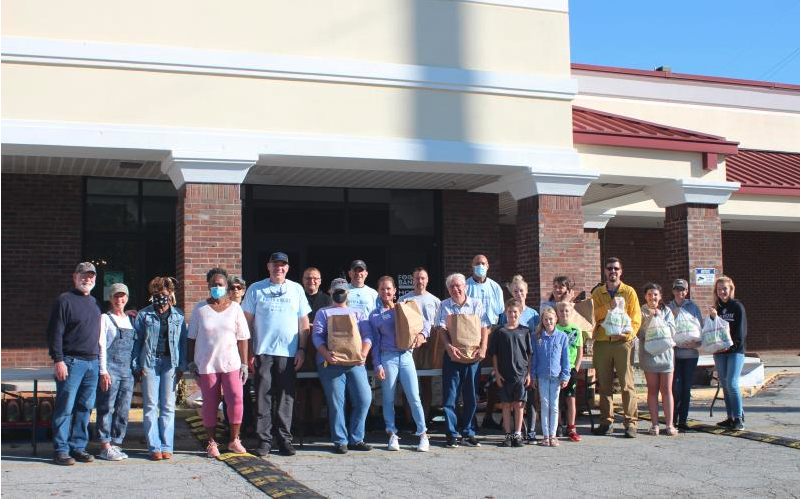 File photo. Local law enforcement agencies and faith-based organizations participate in the Faith &amp; Blue event held at the Food Bank of Northeast Georgia last year by handing out food, diapers and literature with information about various topics to community members.