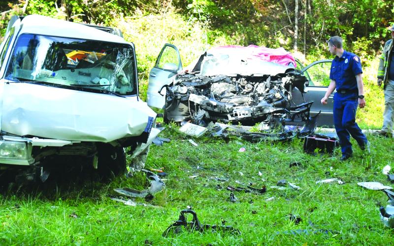 Megan Broome/The Clayton Tribune. Emergency personnel work at the scene of a Sept. 28 two-vehicle crash on Georgia 2 east of McWorter Lane in Rabun County just before the Georgia-South Carolina state line. Two female passengers from Franklin, N.C., suffered fatal injuries as a result of the crash and a Clayton man was life-flighted from the scene with reported serious injuries.