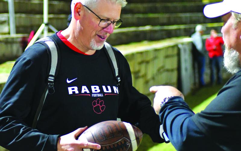 Enoch Autry/The Clayton Tribune. Athletic Director Jason Gibson is given his son’s record-breaking ball.