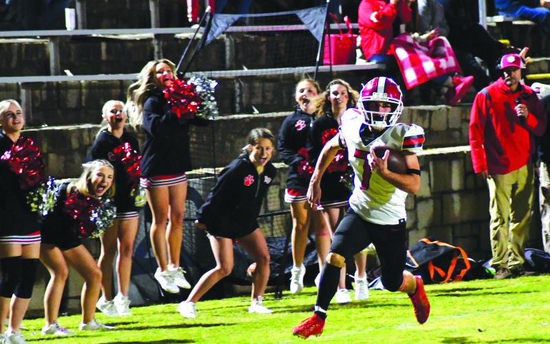Enoch Autry/The Clayton Tribune. RCHS cheerleaders celebrate as senior Lang Windham bolts down the field for a 35-yard touchdown. Windham is heating up in the fall, rushing for over 100 yards the past two weeks with three touchdowns.