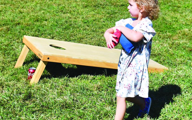 Megan Broome/The Clayton Tribune. Caroline Lynch, 2, plays with beanbags at the Foxfire Mountaineer Festival.