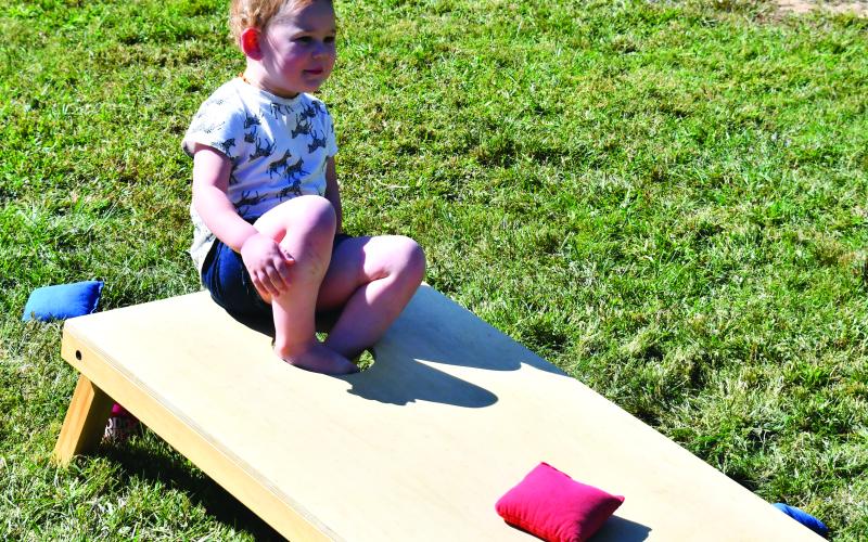 Megan Broome/The Clayton Tribune. Lena Musser, 2, plays with bean bags at the Foxfire Mountaineer Festival.