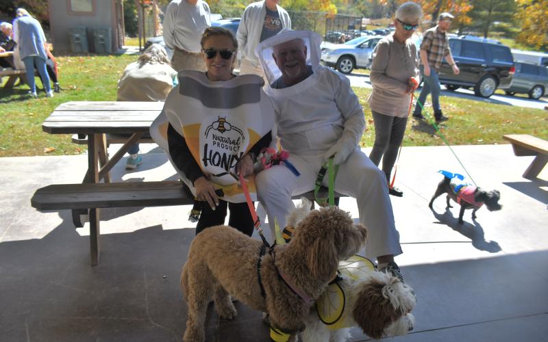 Megan Broome/The Clayton Tribune. The “Bee Colony” won Best Group in the dog costume contest as Diane and Fred Heald dressed as honey and a beekeeper with dogs “Tilly” and “Willow” as bees during the Sky Valley Fall Fest event last weekend.