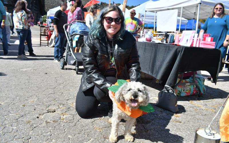 Megan Broome/The Clayton Tribune. Emily Jones poses with her dog, Lila, at the Sky Valley Fall Fest event Saturday, Oct. 15.