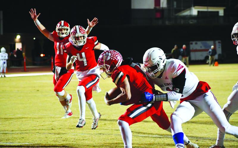 Luke Morey/The Clayton Tribune. Senior running back Lang Windham fights through a tackle for the first touchdown of the night.