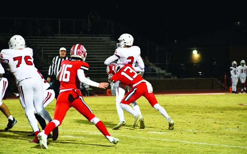 Luke Morey/The Clayton Tribune. With senior Branson Gragg right behind him, senior Gavin Holcomb sacks quarterback Logan Cross in the fourth quarter. Holcomb and the Wildcat defense pitched a shutout against Social Circle to advance to the Elite Eight against Swainsboro on Nov. 25.