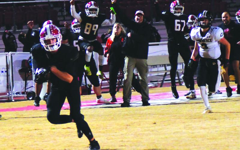 Enoch Autry/The Clayton Tribune. With the sideline celebrating, Jarret Giles races to the end zone on a 49-yard TD reception.