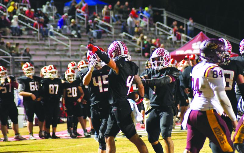 Enoch Autry/The Clayton Tribune. Noah Legault points in the opposite direction after the senior intercepted a Dade County pass. RCHS will host Social Circle Friday night in the state quarterfinals.