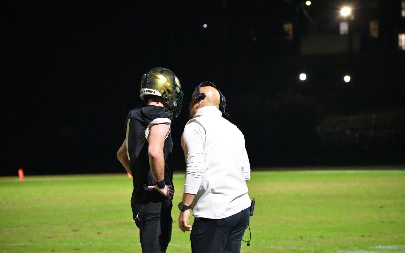 Luke Morey/The Clayton Tribune. Horne talks with head coach Derek White after his second touchdown of the night. Horne accounted for seven of the team’s 10 touchdowns in the playoffs.