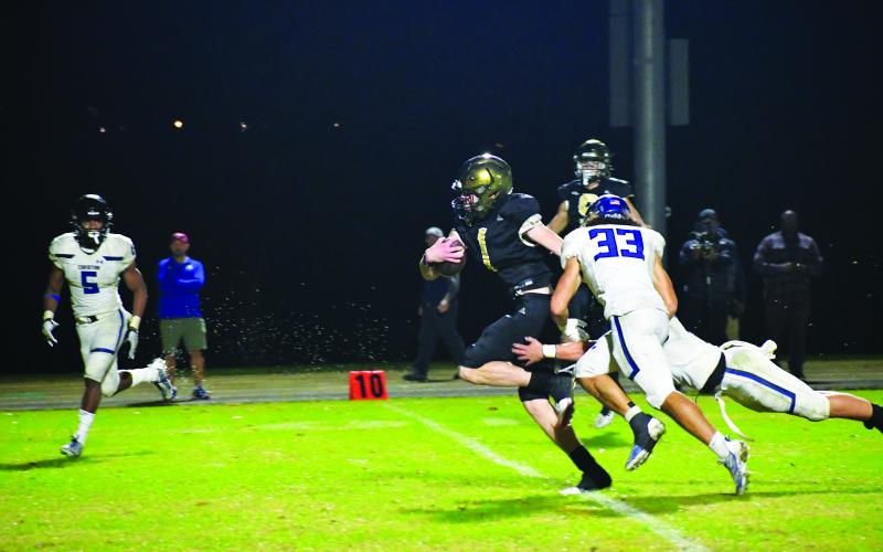 Luke Morey/The Clayton Tribune.  Junior Trey Horne breaks through two arm tackles on his way to his third touchdown of the night. Horne rushed for over 150 yards on Friday night.