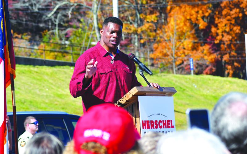 Enoch Autry/The Clayton Tribune. U.S. Senate candidate Herschel Walker addresses the crowd at his campaign stop in Dillard at the Piggy Wiggly parking lot.