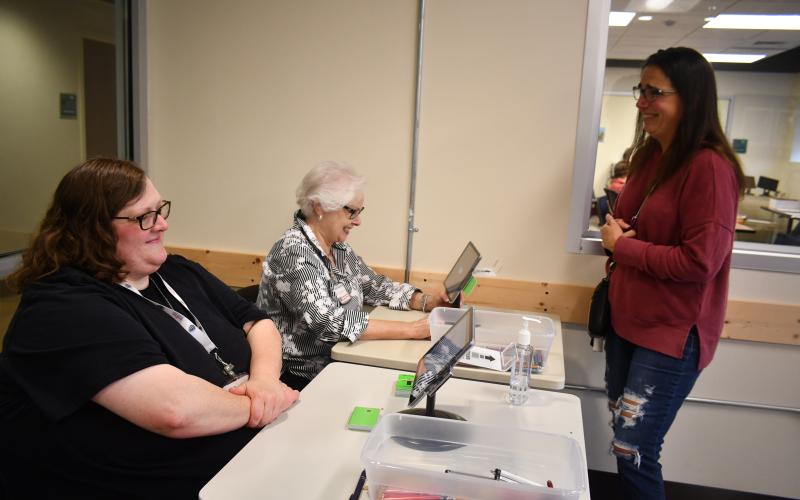 Megan Broome/The Clayton Tribune. Voter Lisa Causin verifies her information with poll workers Amanda Burrell, left, and Ann D’Agostino before casting his ballot on Election Day Tuesday at the Rabun County Board of Elections Office.