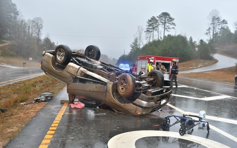 Megan Broome/The Clayton Tribune. First responders work the scene of a single vehicle crash for a vehicle that overturned on Ga. 15 at Razorback Lane in Lakemont Nov. 11. The driver, a Clarkesville, Ga. man, sustained possible minor injuries as a result of the crash.