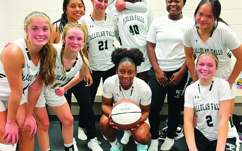 TFS Athletics. Senior Denika Lightbourne (center) poses with her TFS teammates after scoring 1,000 points in her career. She now holds three school records as well as being the fifth Lady Indian to score 1,000 points.