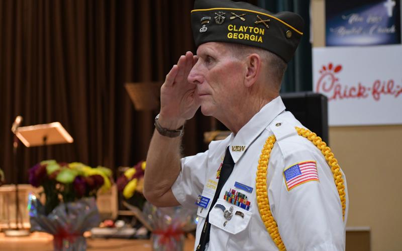 Megan Broome/The Clayton Tribune.  Veteran Jon Jones, with VFW Post 4570, salutes as the National Anthem is sung and colors are presented at the Veterans Appreciation Dinner on Nov.10 in Clayton at the Rabun County Civic Center.