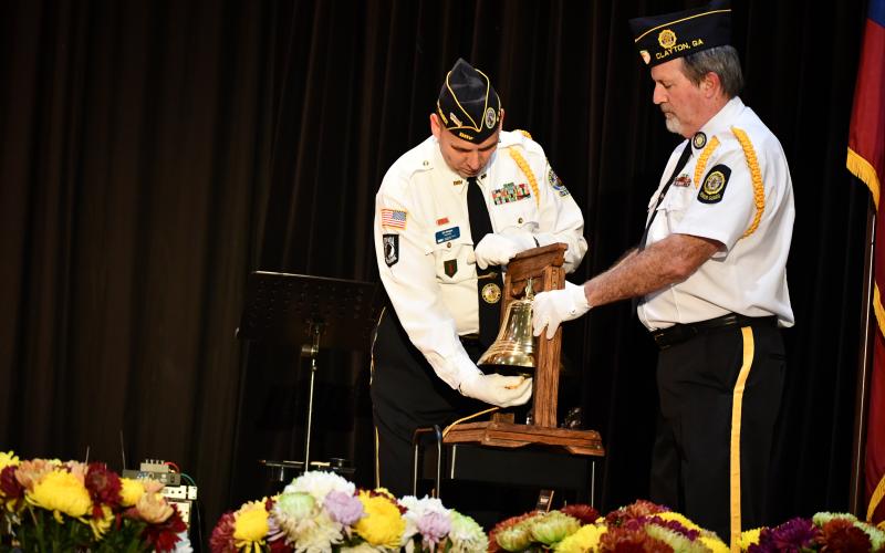 Megan Broome/The Clayton Tribune. Veterans Jim Morgan and Chris DiNofrio ring the bell during a ceremony honoring veterans at the Veterans Appreciation Dinner.