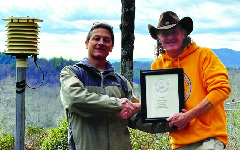Submitted photo. Anthony Lampros, right, receives a certificate from National Weather Service Meteorologist Chris Horne in recognition of over 20 years of service for weather observation in the area.