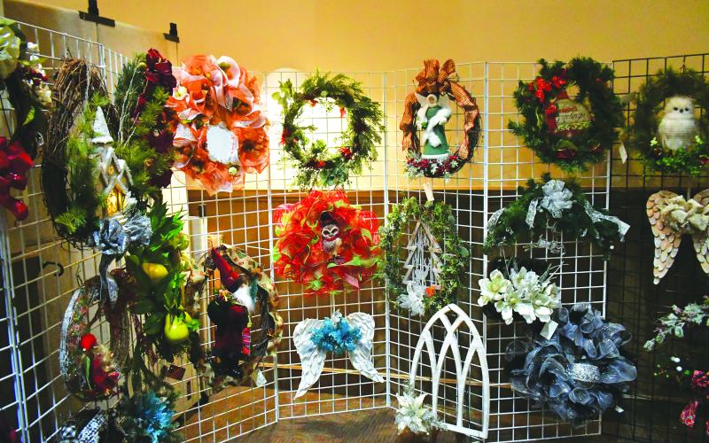 Luke Morey/The Clayton Tribune. C.L.G Designs offered decorative wreaths and floral arrangements during the “Arts and Crafts Shopping Extravaganza &amp; Festival of Trees” on Nov. 25 and Nov. 26 at the Rabun County Civic Center. The event was free as 39 artists and crafters offered a variety of items. The Festival of Trees benefitted the Kiwanis Club of Rabun County. More than 30 decorated trees were available for bidding.