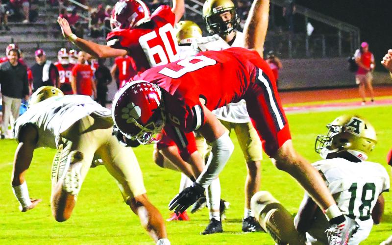 Luke Morey/The Clayton Tribune. Gibson flips into the endzone for his third touchdown against Adairsville.