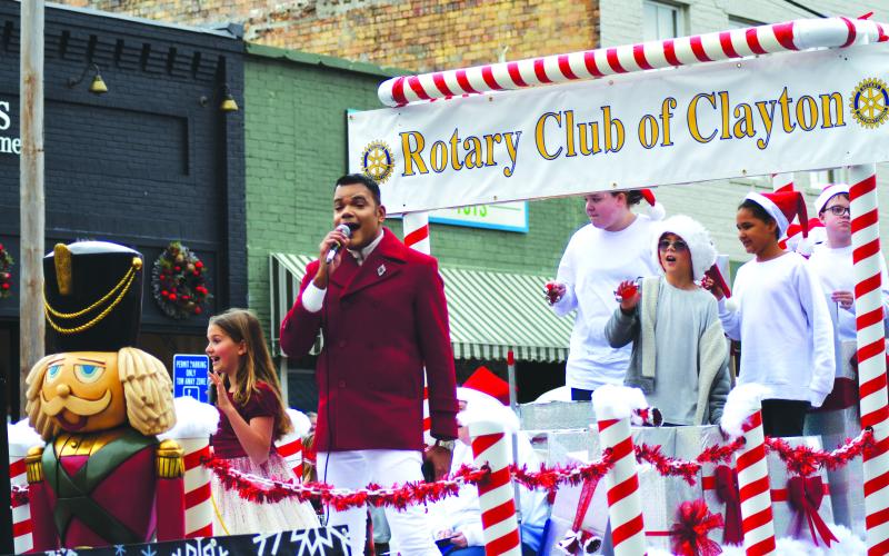 Enoch Autry/The Clayton Tribune. Ishmael Santos and children Bella Ciochetti, Joset Vernes and Steve Webster are among those riding on the Rotary Club of Clayton’s Christmas Parade float on Main Street on Dec. 3.