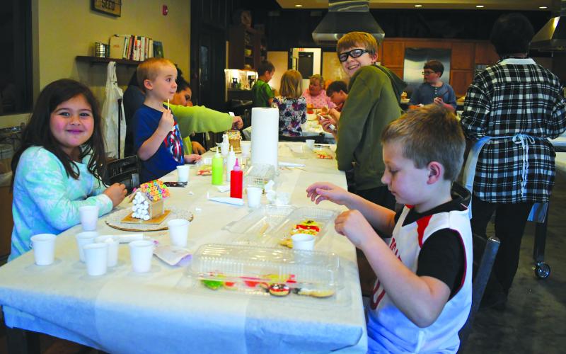 Enoch Autry/The Clayton Tribune. Blake Olivia Ruiz, Parker Cavender, Holden Cavender, Brantley Cavender and Easton Cavender decorate gingerbread houses and cookies on Dec. 15 at the Teaching Kitchen. The event was free as the children got to create and eat.