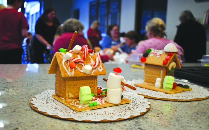 Enoch Autry/The Clayton Tribune. Children got the chance to decorate Christmas cookies and gingerbread houses for free at the Food Bank of Northeast Georgia on Dec. 15. With an adult, the youth dropped by the Teaching Kitchen to practice their decorating techniques, learn about royal icing, and create beautiful treats to take home. Recipes also were provided.