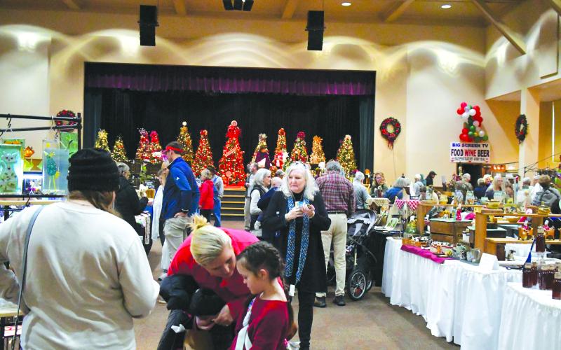 Luke Morey/The Clayton Tribune. Hundreds of visitors showed up to the Festival of Trees on Nov. 25 and 26 to see the 39 vendors who offered an array of items including mugs, wreaths, candles, award-winning BBQ sauce and paintings.
