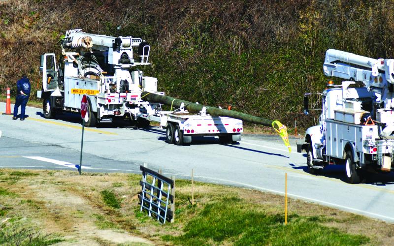 Enoch Autry/The Clayton Tribune. Crews bring in a new power pole on Worley Creek Road to replace a pole damaged by the gusting winds on Dec. 23 as the temperatures in the county dipped below zero.