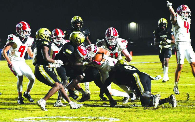 Luke Morey/The Clayton Tribune. RCHS junior Paul Piccioti gets a shove from senior tackle Mike Swager to get a first down in the first quarter of the GHSA quarterfinals.