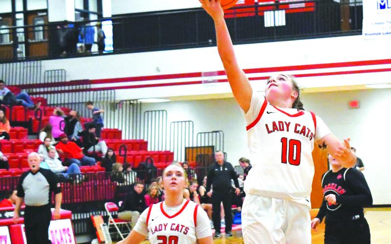 Luke Morey/The Clayton Tribune. With junior Ellie Southards right behind her, junior Mili Watts finishes the fast break with a layup against Franklin on Saturday, Dec. 10. A defensive stalwart for the Wildcats, Watts has notched five or more steals in four of the six games this season.