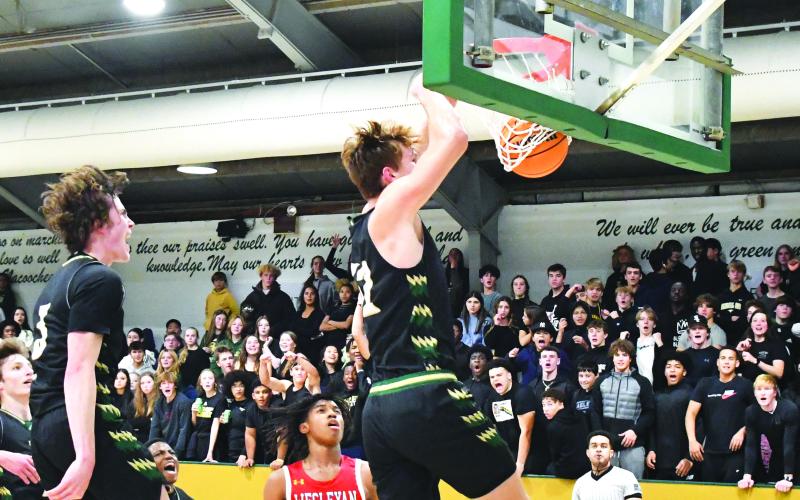Luke Morey/The Clayton Tribune. Senior Theo Antinori celebrates as senior Domas Kauzonas slams home a dunk on Friday, Dec. 2.  Both seniors have helped the Eagles to a 12-4 start to the season.