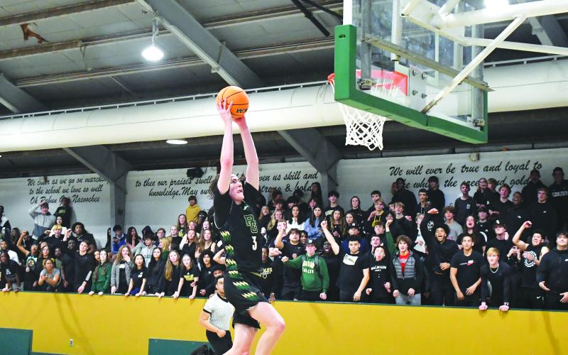 Luke Morey/The Clayton Tribune. Senior Theo Antinori ends the fast break with a dunk as the student section goes wild on Friday night. Antinori had 29 points on Friday before going off for 30 on Saturday.