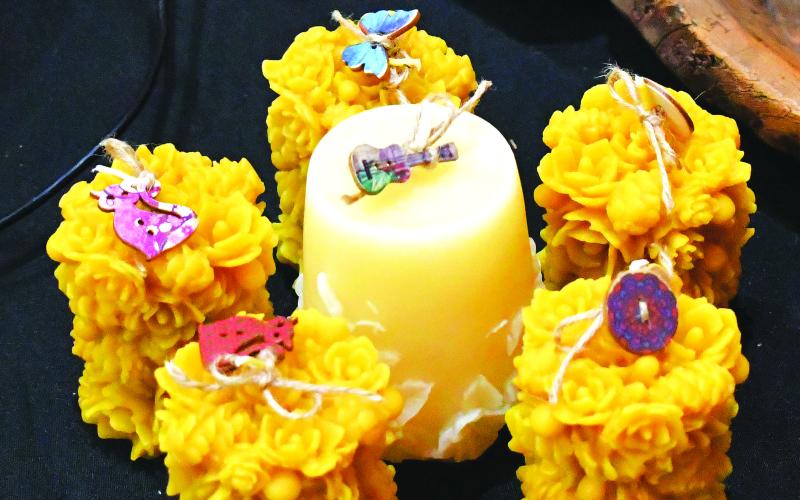 Luke Morey/The Clayton Tribune. Four Barns Farm from Union County presented intricate beeswax candles. The owners of the small farm that holds over 120 animals found this craft after the cost of buying candles became too expensive.