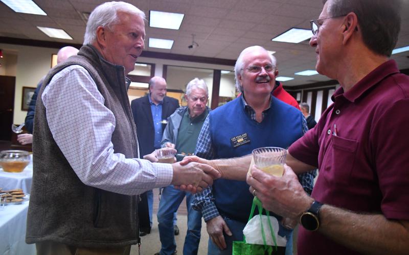 Megan Broome/The Clayton Tribune. Chip Goen and Lee Penland meet with Greg Funkhouser at his retirement reception held at Rabun County Bank Dec. 14. Funkhouser retires after 43 years of service to Rabun County Bank.