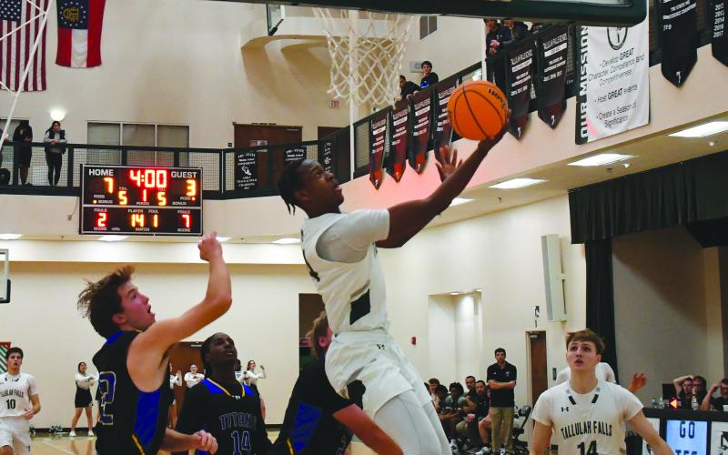 Luke Morey/The Clayton Tribune. Senior Anfernee Hanna hits a reverse layup in the first quarter aganst Lake Oconee Academy on Wednesday, Dec. 7. Hanna put up 56 total points over the past three games helping the Indians to a four game winning streak before falling to Oglethrope County.