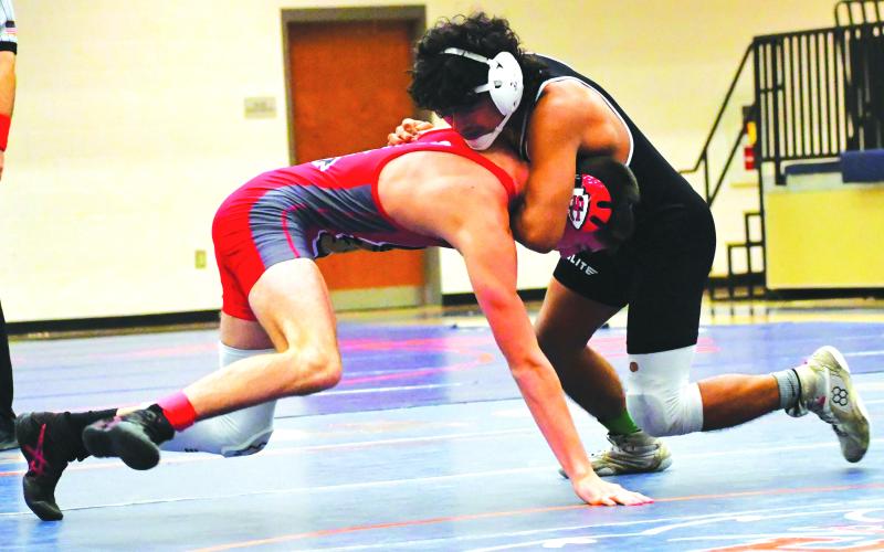 Luke Morey/The Clayton Tribune. Rodolfo Ramos gets a chokehold on Tucker Kinsey from Stephens County in the placement match during the Raider Invitiational on Saturday, Dec. 10. Ramos won his weight class after defeating Kinsey.