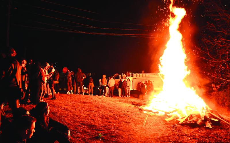 Megan Broome/The Clayton Tribune. Crowds of people from the community and students from Tallulah Falls School enjoy mingling and hanging out at the bonfire during the Town of Tallulah Falls Christmas Party Dec. 2.